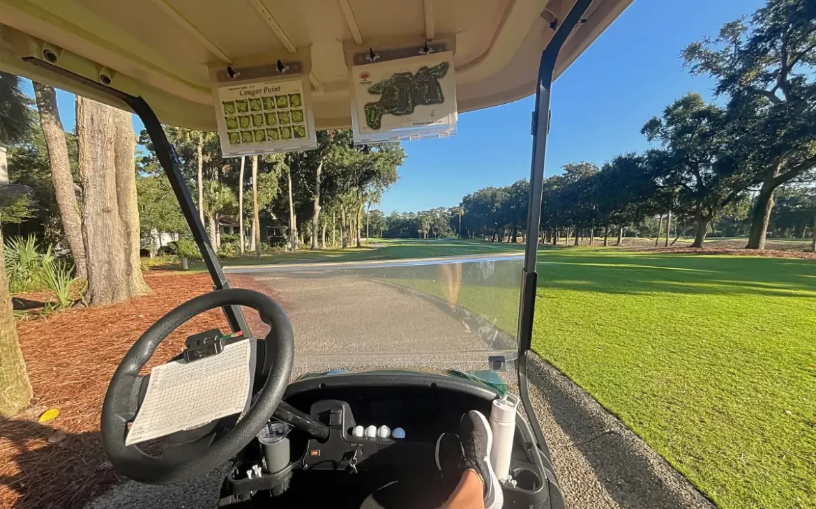 Image showing that the carts at Cougar Point golf course are a little behind the times with only printed out maps attached, as opposed to electronic screens