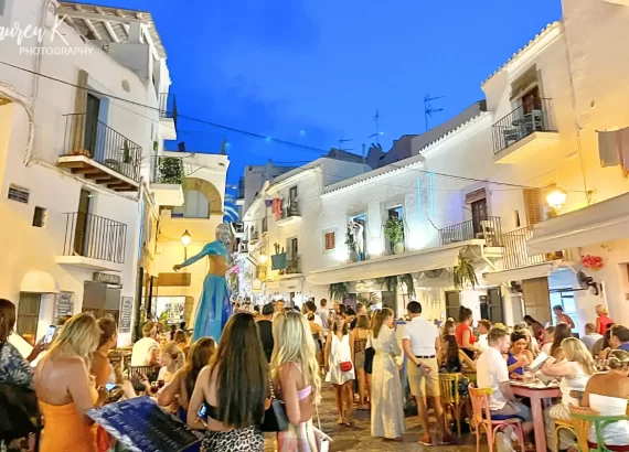 Ibiza at night in the town, with performers and peolpe enjoying themselves in a lively atmosphere