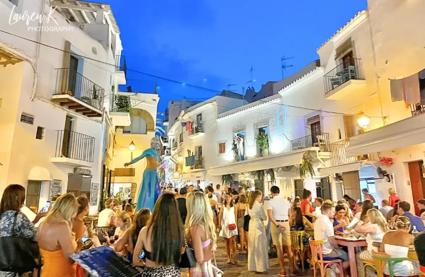 Ibiza at night in the town, with performers and peolpe enjoying themselves in a lively atmosphere