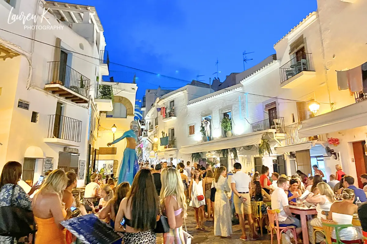 Ibiza at night in the town, with performers and peolpe enjoying themselves in a lively atmosphere