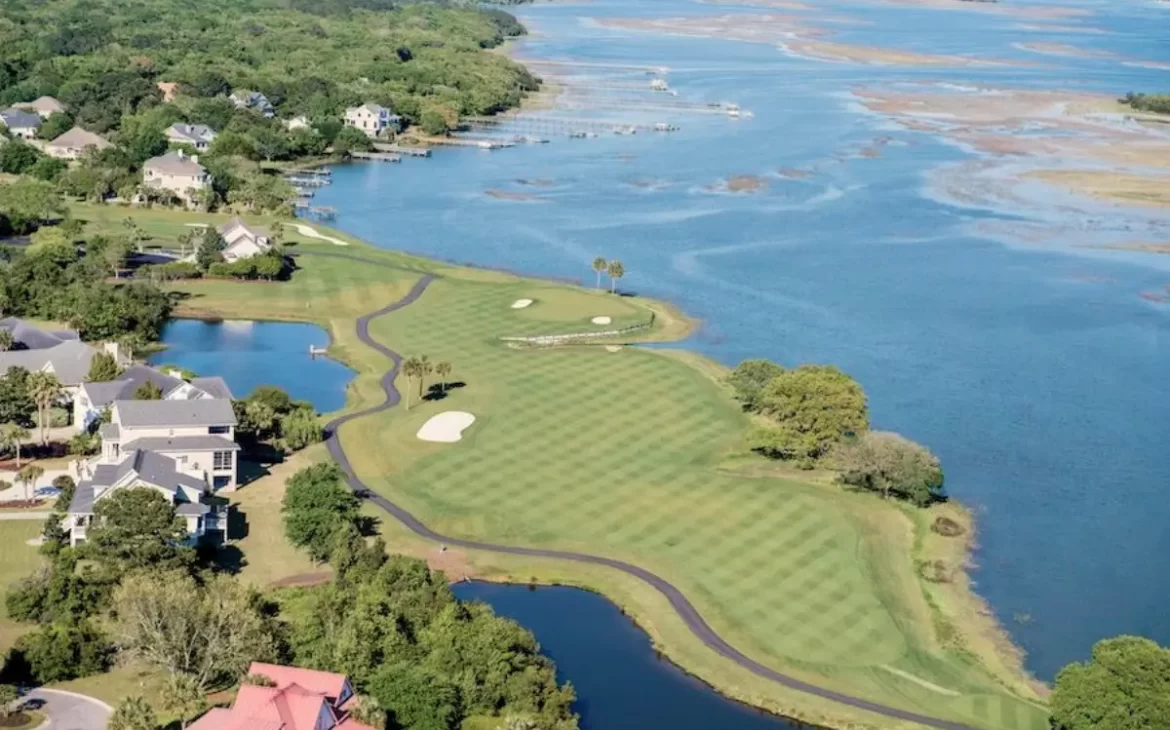 Aerial view of the Oak Point golf course with the hole surrounded by water