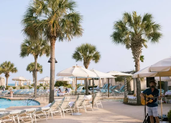 Cover image for Where to Stay On Kiawah Island blog, showing the pool and a live musician at The Sanctuary